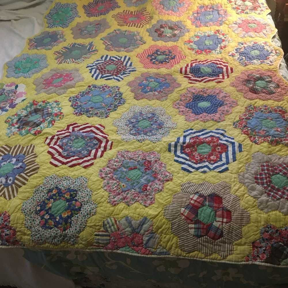 Vintage twin size quilt “Grandma’s flower garden” pattern.  Measures 56 x 79.